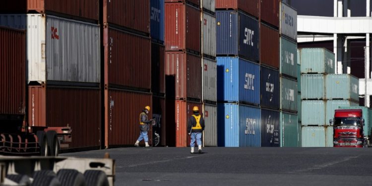 Japan’s exports rise faster than expected, helped by weaker yen