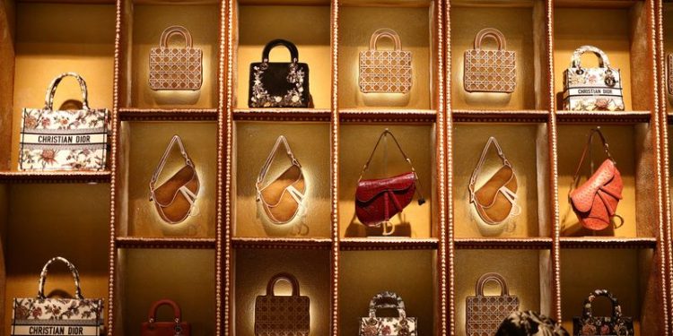 Luxury labels bulk up on lower-priced goods to appeal to middle-class shoppers