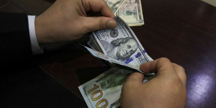 Dollar trades near one-week low as market ponders Trump tariffs