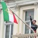 Protester scales Iranian Embassy in London, tears down regime flag, hoists pre-revolution symbol